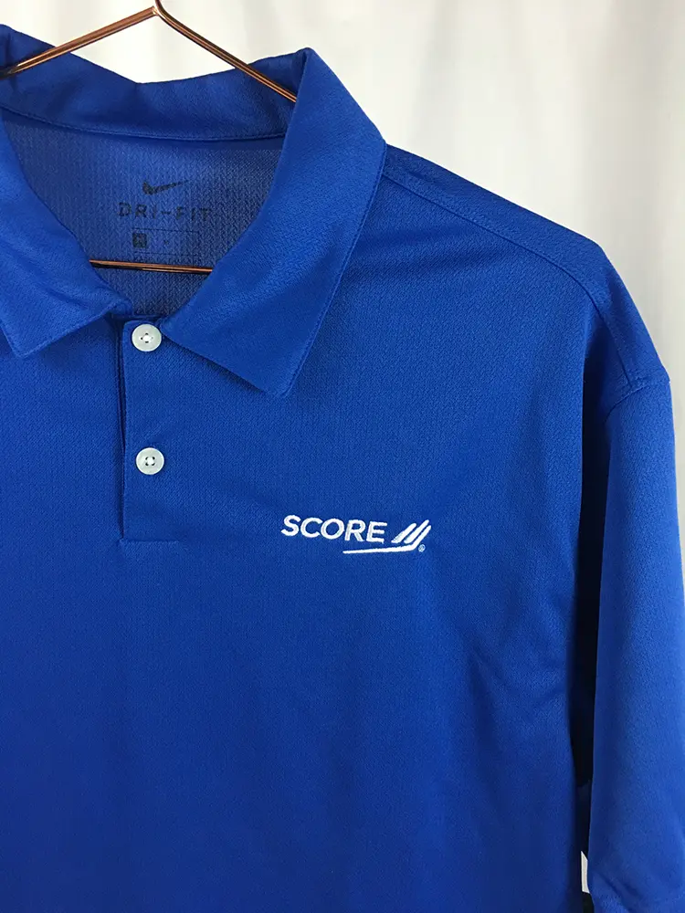 Nike Dri-Fit micro pique polo shirts with white embroidery for business mentorship organization uniforms