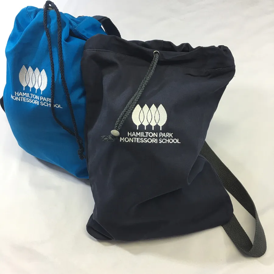 Embroidered drawstring backpacks for Montessori school children with custom educational institution branding