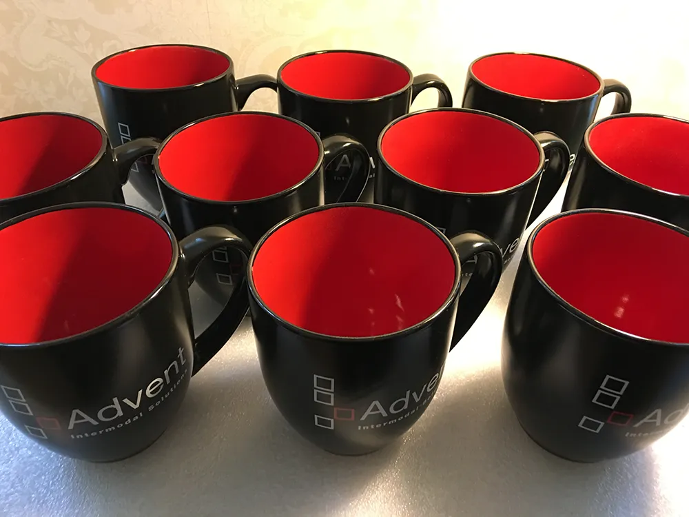 Two-tone ceramic bistro mugs with glossy finish and custom logistics company logo printing