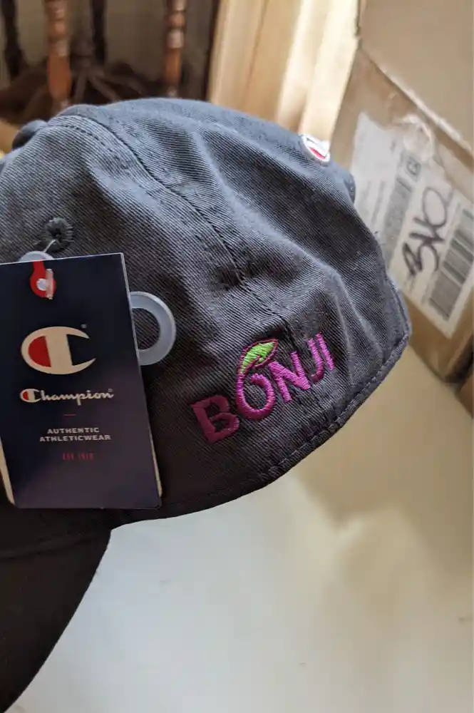 Custom embroidered Champion baseball cap with Bonji Foods logo. Premium athletic headwear for food industry promotional apparel & uniforms.