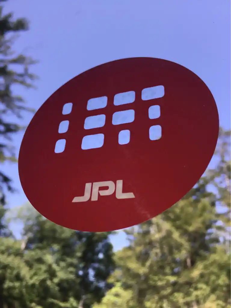 Transparent removable window clings with aerospace laboratory branding for office glass applications