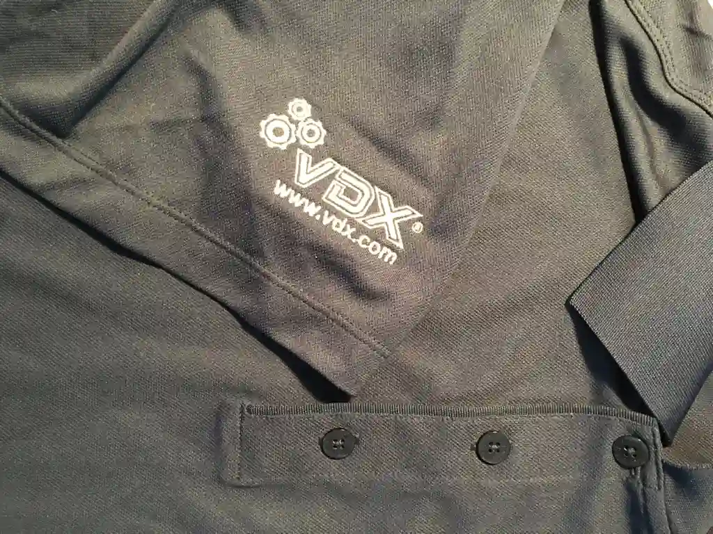 Grey polo shirt with custom embroidered sleeve logo for software company employee uniforms