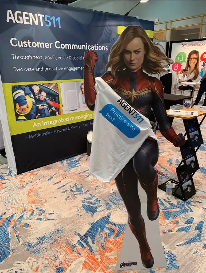 Trade show booth setup with 10x10 full color banner backdrop and custom branded t-shirt display