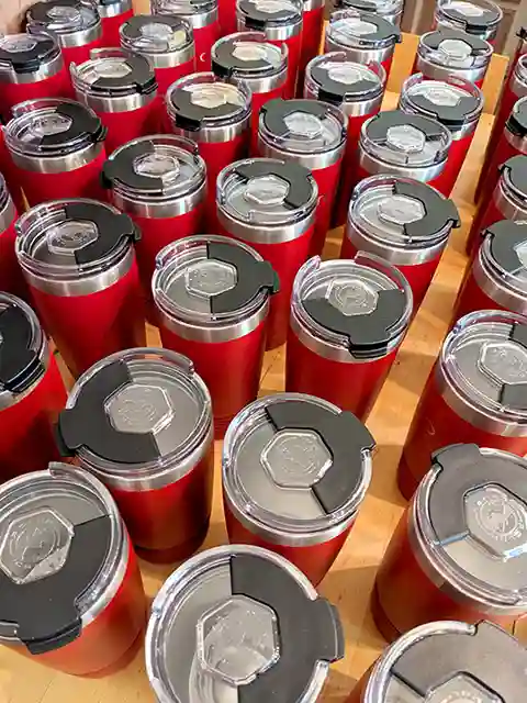 Laser engraved red vacuum insulated tumblers with snap lids for pharmaceutical company branding