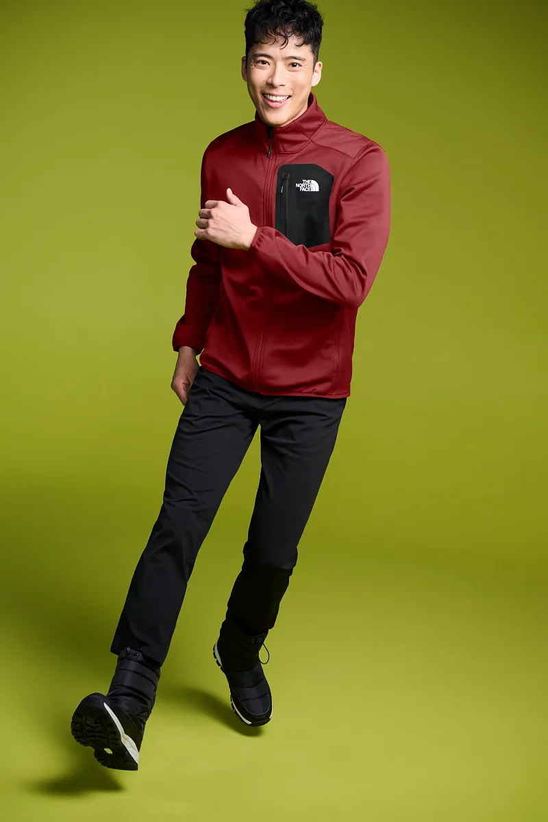 Man wearing a red and black The North Face softshell jacket