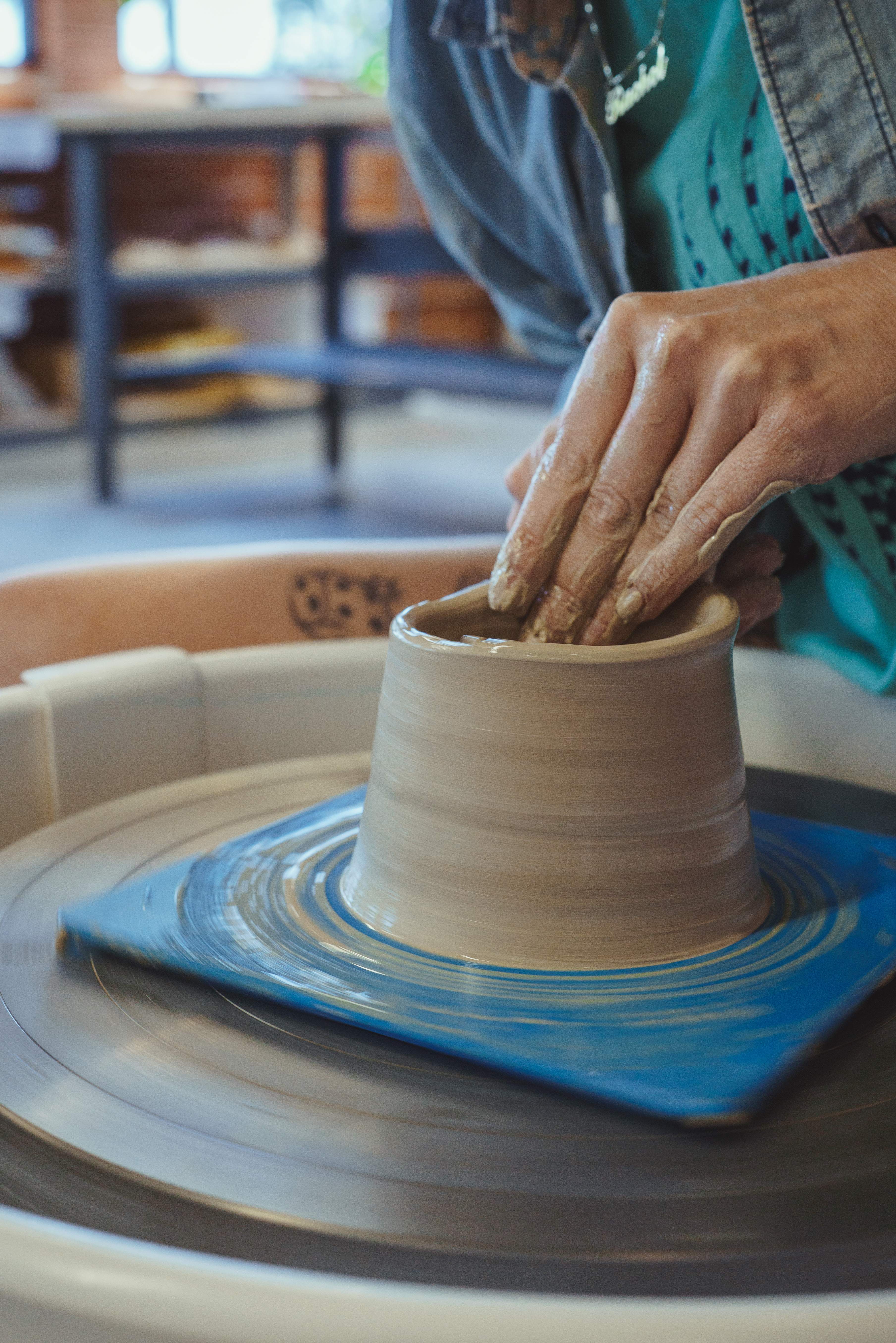 Hands molding a bowl