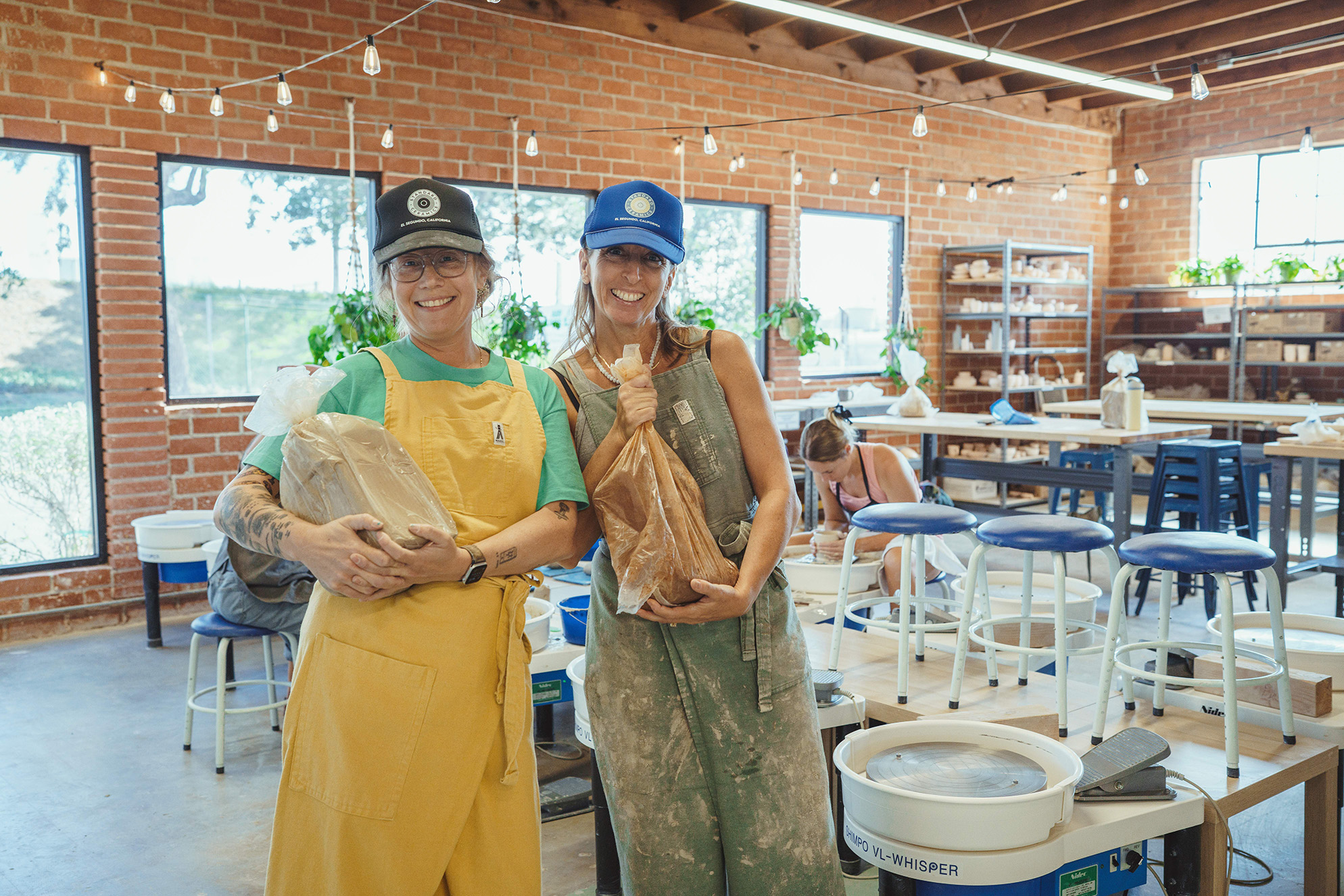 Standard Ceramics co-founders with bags of clay, the raw material for the work and community they’ve built in Smokey Hollow