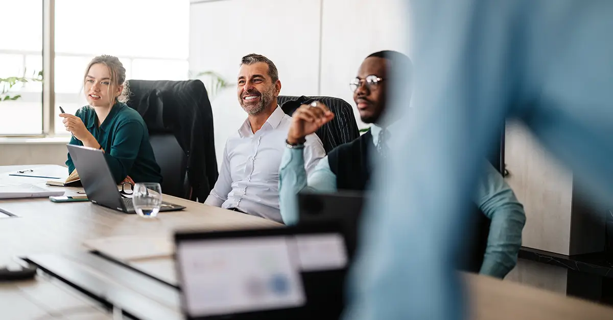 Diverse team of professionals engaged in a collaborative meeting, symbolizing enterprise evaluation of Leah Agentic CLM vs Sirion CLM for contract management.