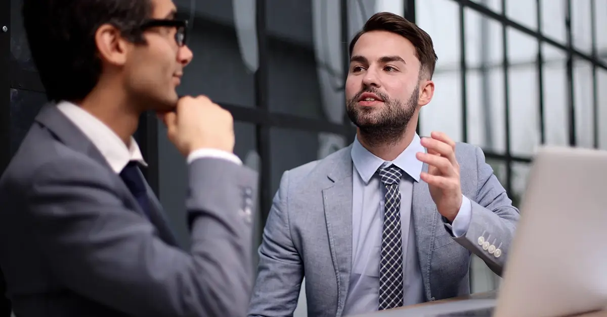 Business executive in conversation during an office interview.