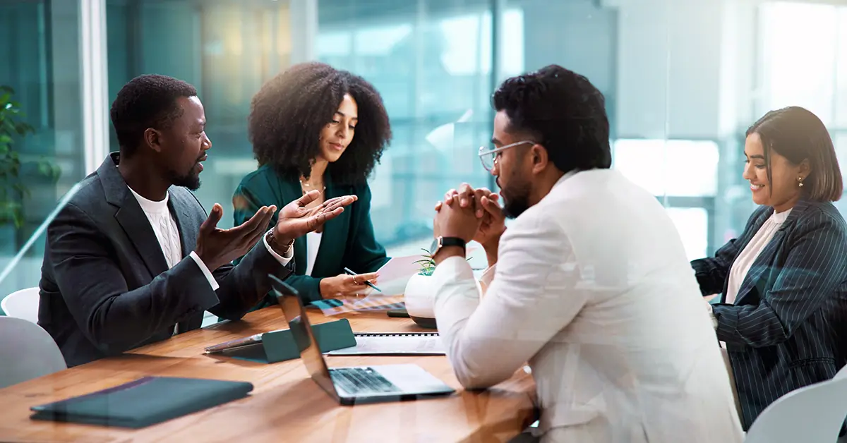 Business team collaborating in a modern office meeting, discussing contract workflows and strategy to avoid failed CLM implementation and improve adoption.