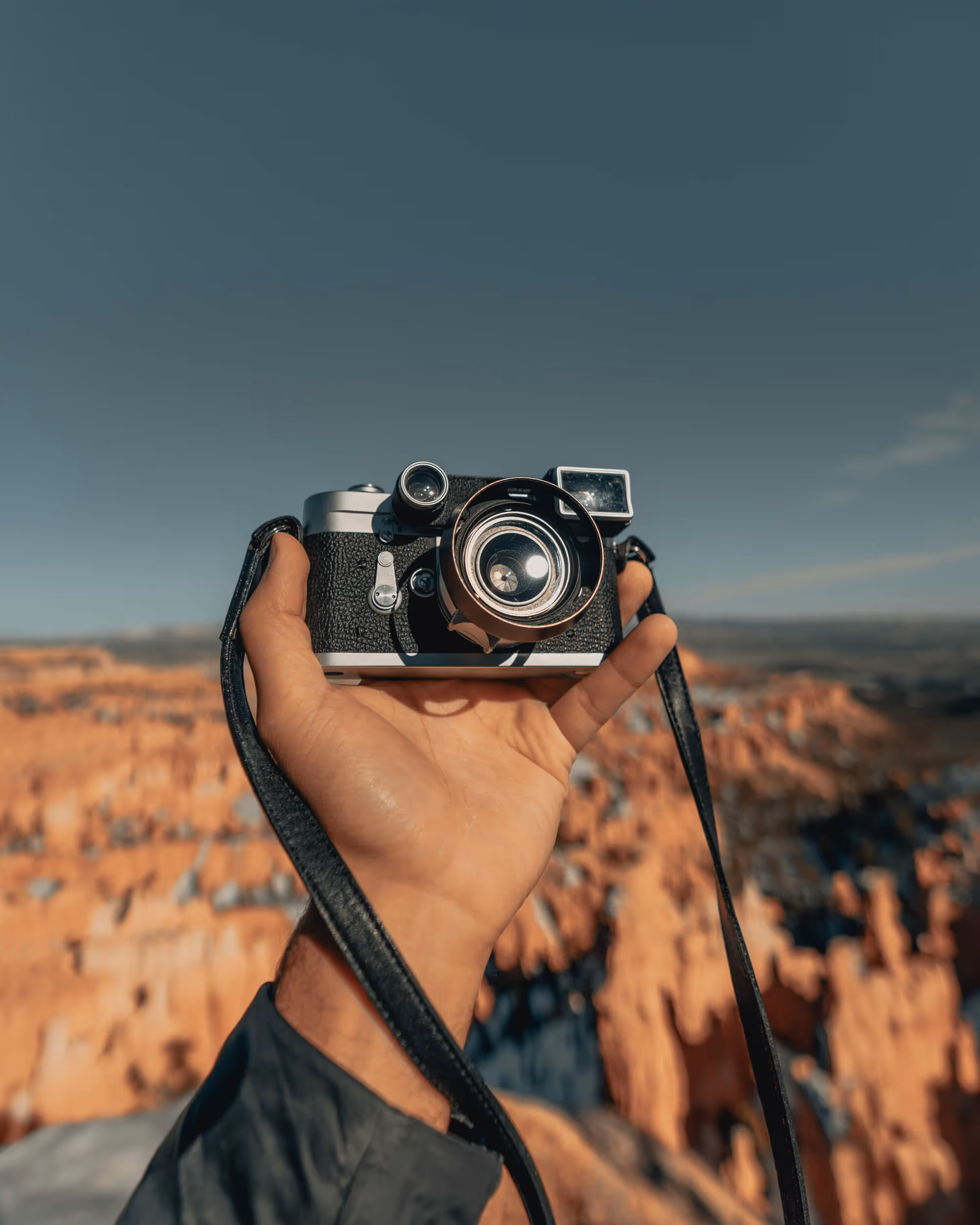 Holding a camera in a national park.