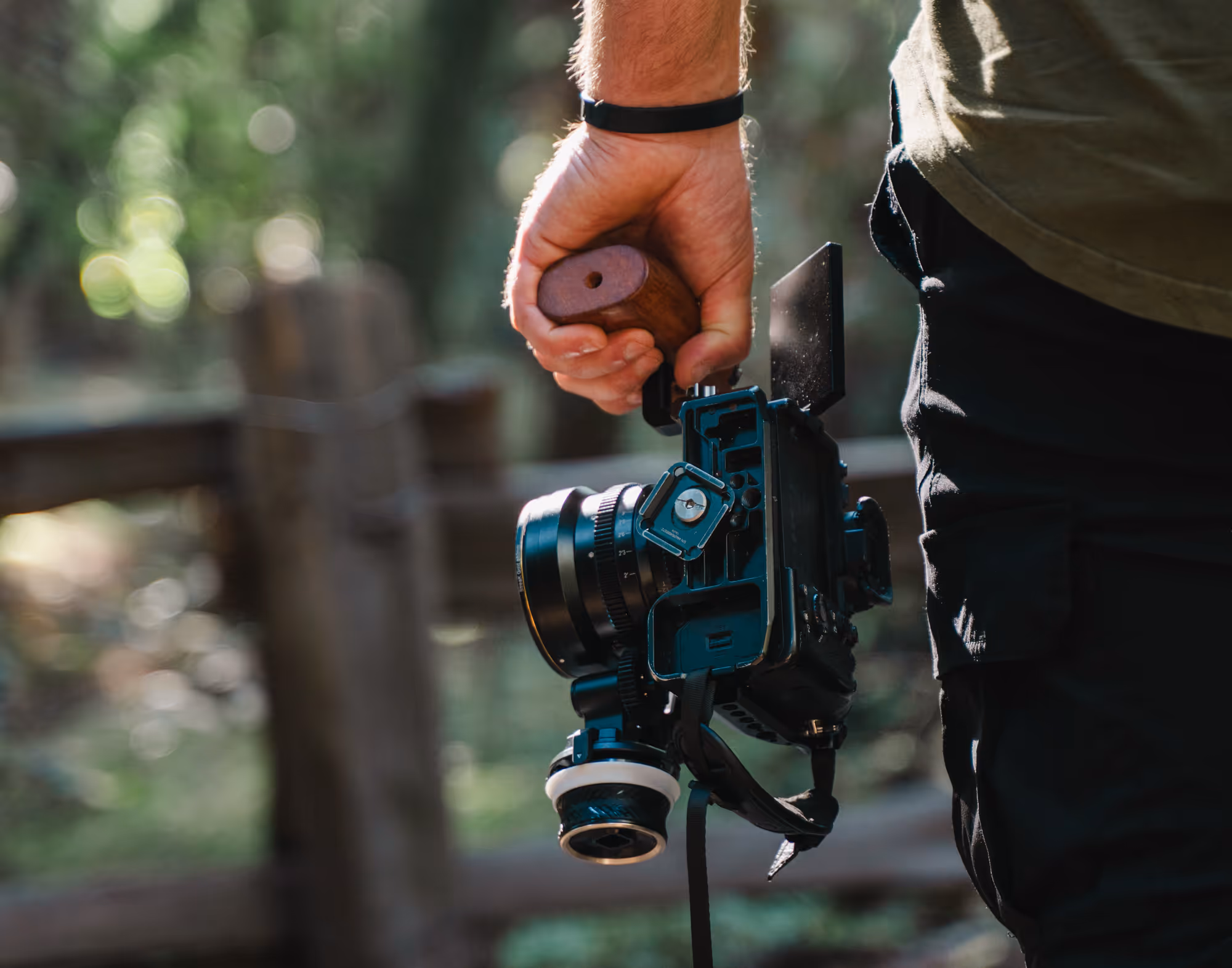 a male hand holding a camera with a stabilizer