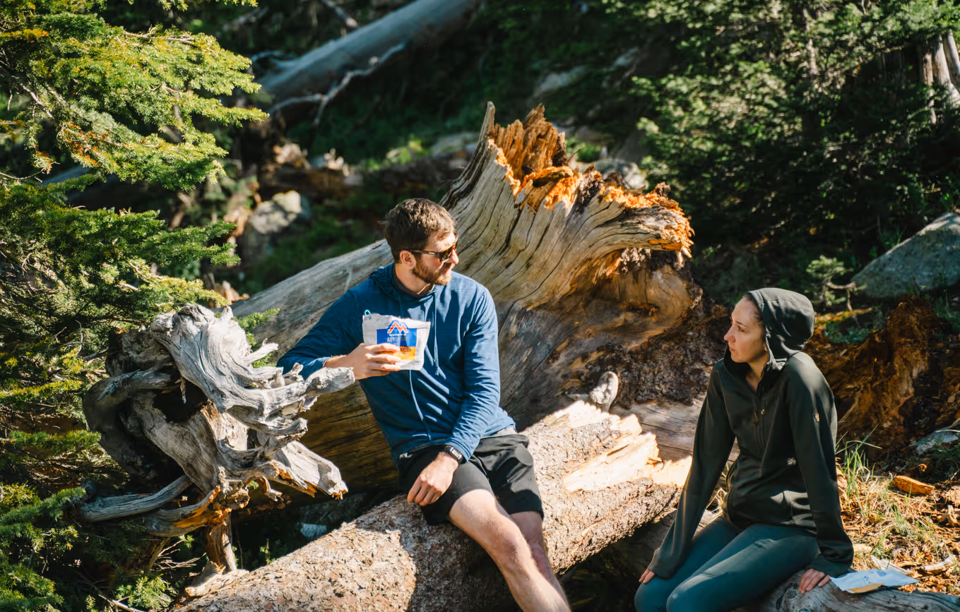image of a couple enjoying food in the mountains