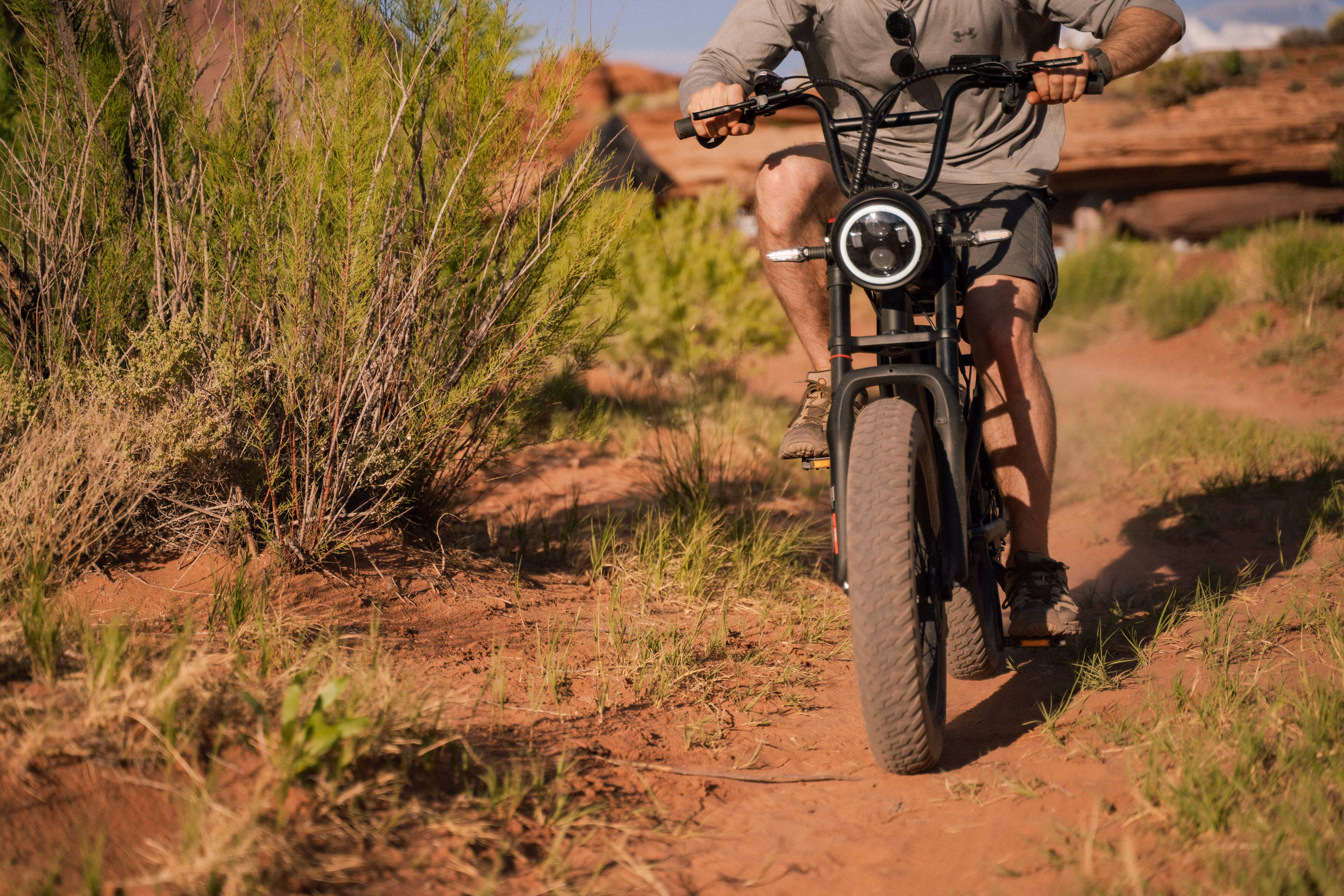 Photo of cyclist on E-bike in the desert.
