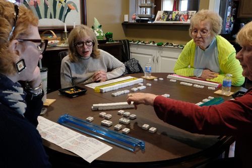 Friends have played a big part in helping Marilyn Delanoeye cope with the loss of her husband of 31 years. Here, she is learning how to play mahjong with friends she’s known for years.