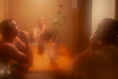 River sailors, from left: Piotr Karpacz, cpt. Czeslaw Szarek, Zbigniew Laskowski - crew of a transportation ship rests in the evening after a day of work.