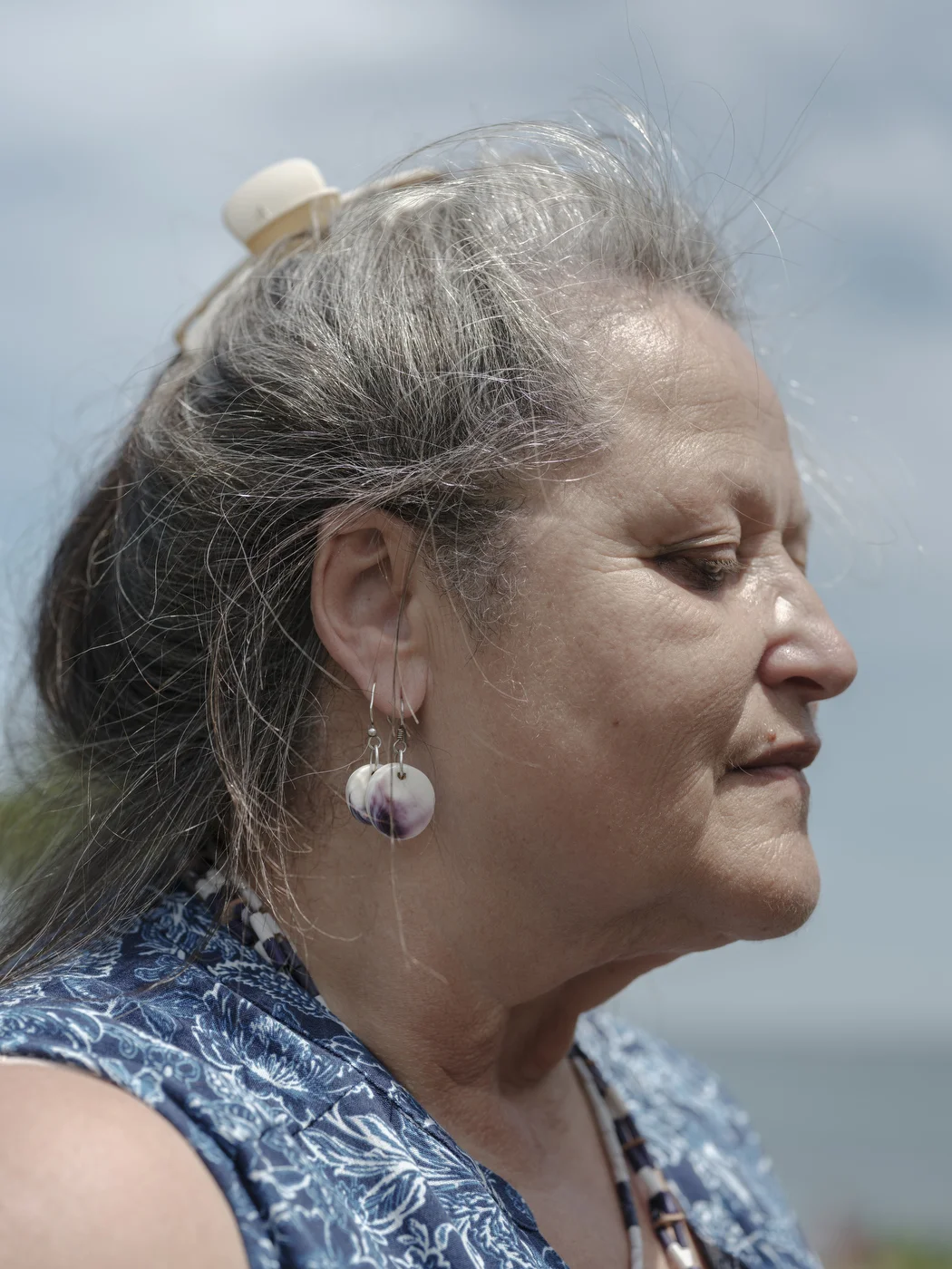 Rev. Holly Haile Thompson- DD; Padaquohan Medicine Lodge, Inc., and Niamuck Land Trust-wears earrings made out of qauhog clam shell pieces.