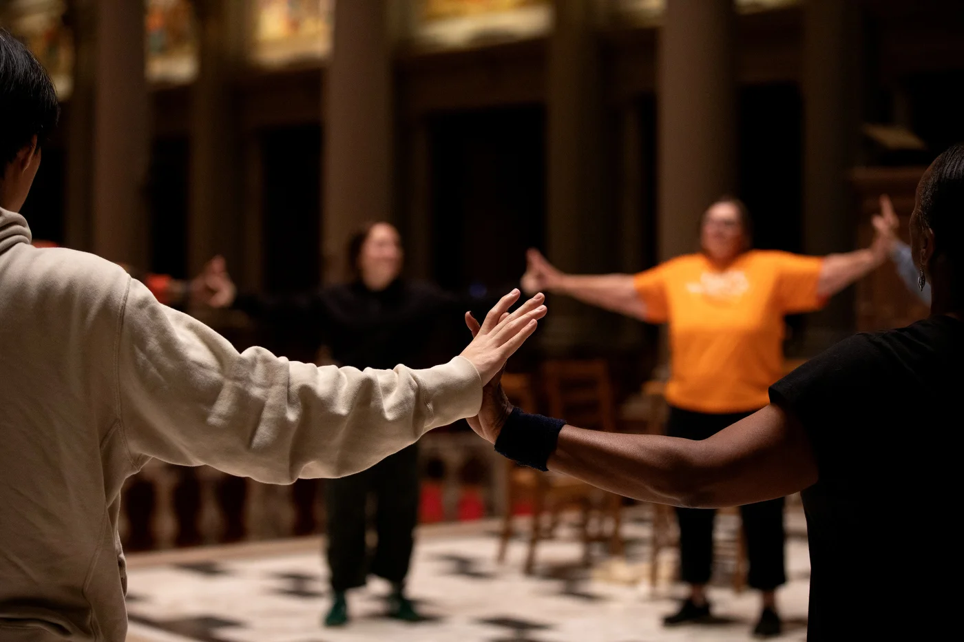 Young and elder hands touching, connecting. Touch becomes rhythm, and generations move as one.