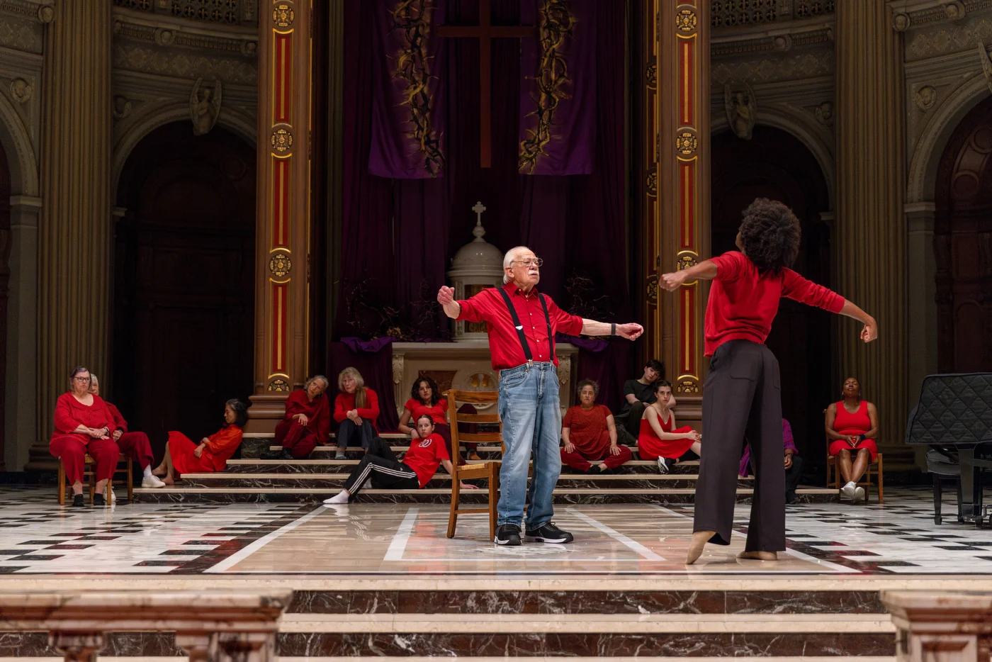 The principal dancer faces his elder, chest lifted and open, embodying a quiet surrender to shared spiritual belief.