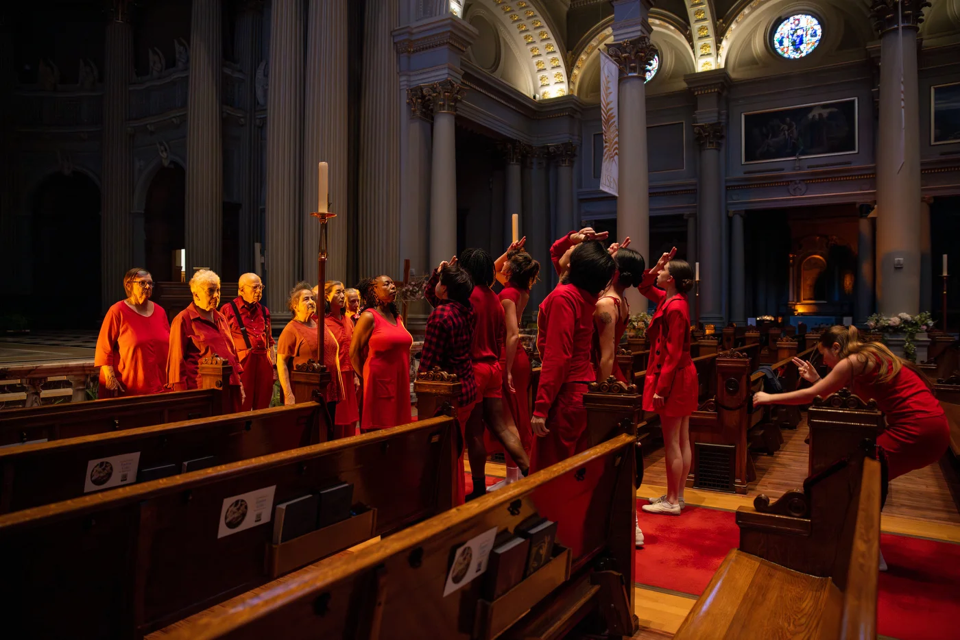Young and old connect, their hands rising in a mudra — a silent gesture of harmony and unity within a sacred space.