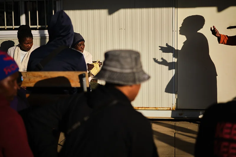 Shelta Nhengo, 75, a community health worker addresses patients visiting Mbare hostel clinic.