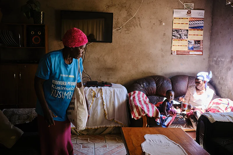 Shelta Nhengo, 75, inside her house in Mbare township talks to Chipo Mabiye, 22, niece and her 1yr 8 months baby Adele daughter who also doubles as a house help. 