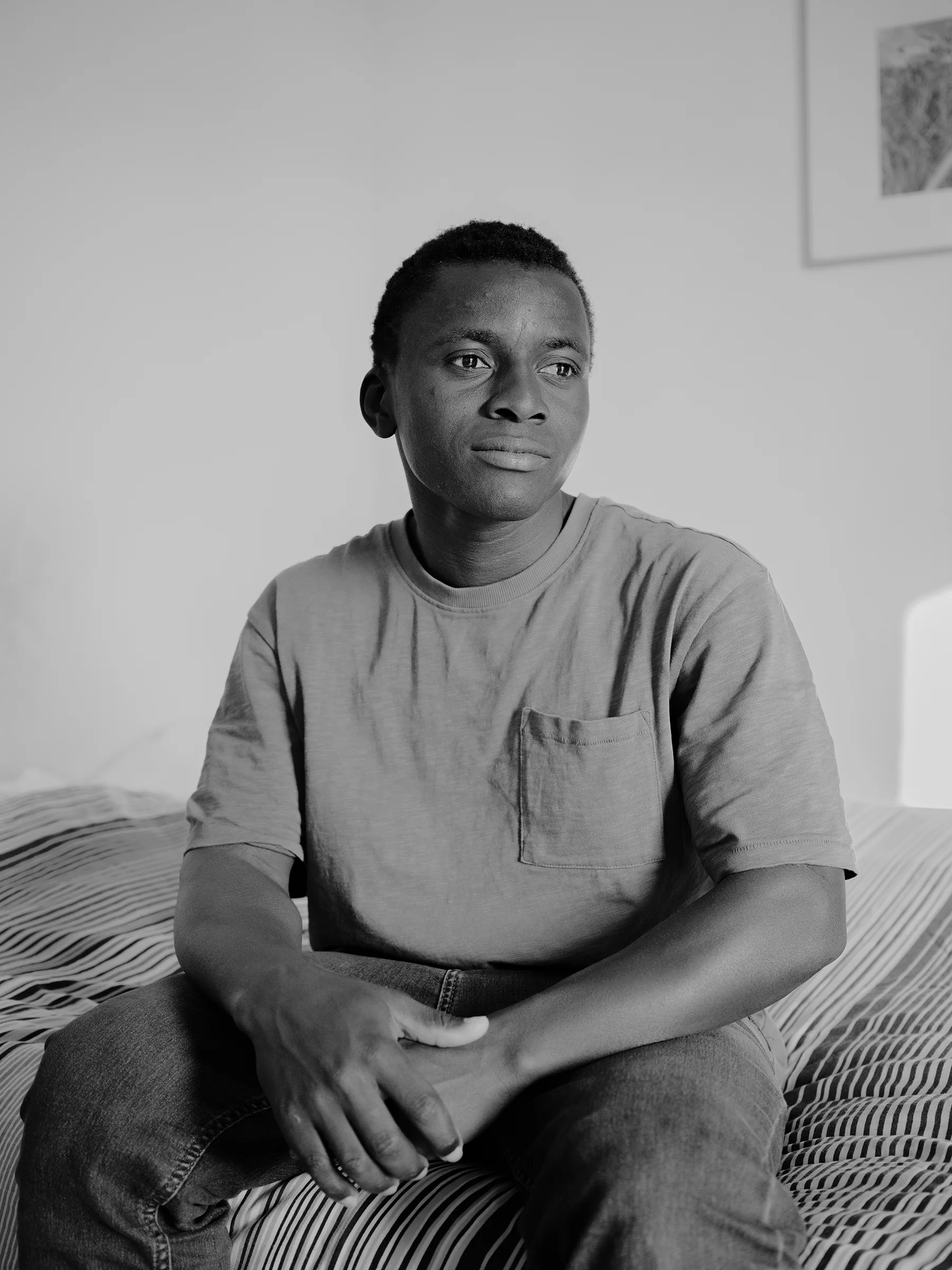 Ousmane16-year-old, in his tidy room at Marianne’s home, where he stayed briefly before moving between other families.