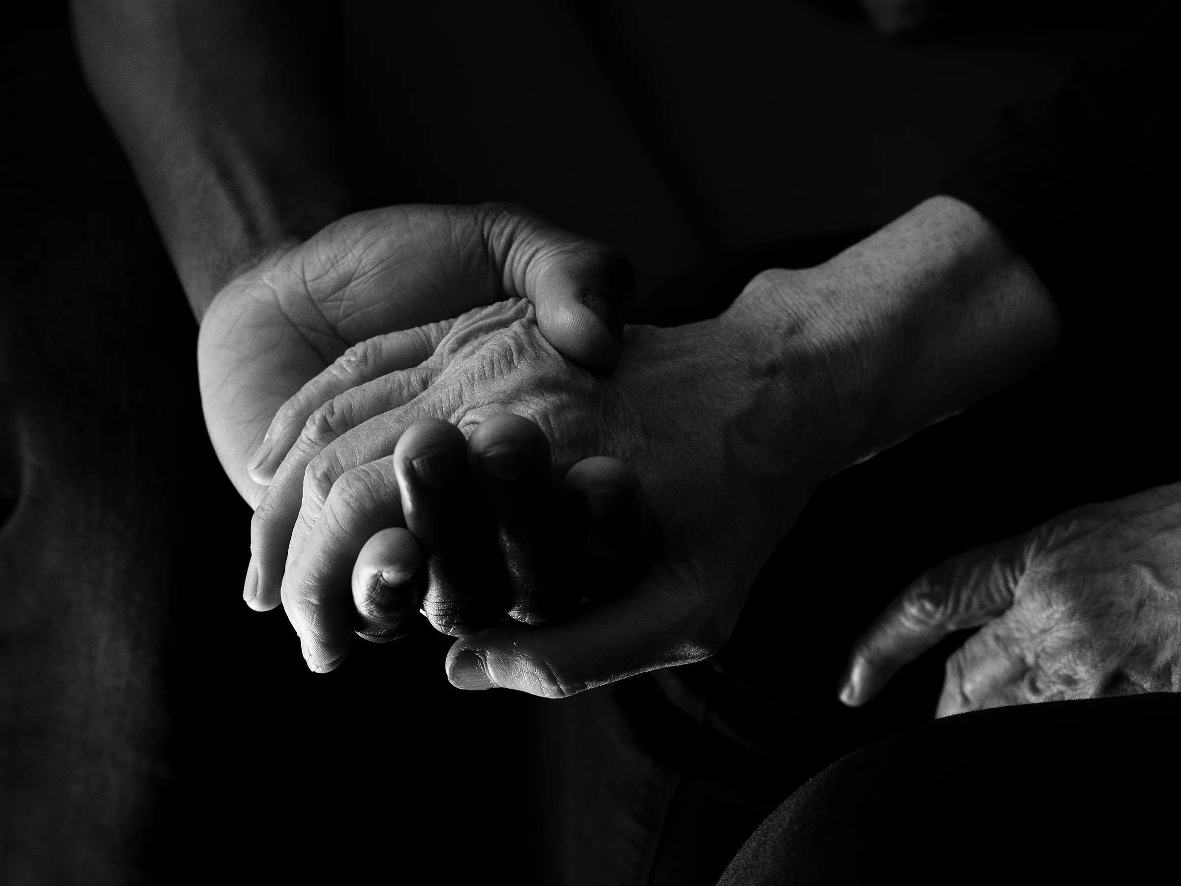 Ahmed and Véronique holding hands in Ahmed’s home in Le Havre. After years of living together, Véronique adopted Ahmed, who now lives independently.
