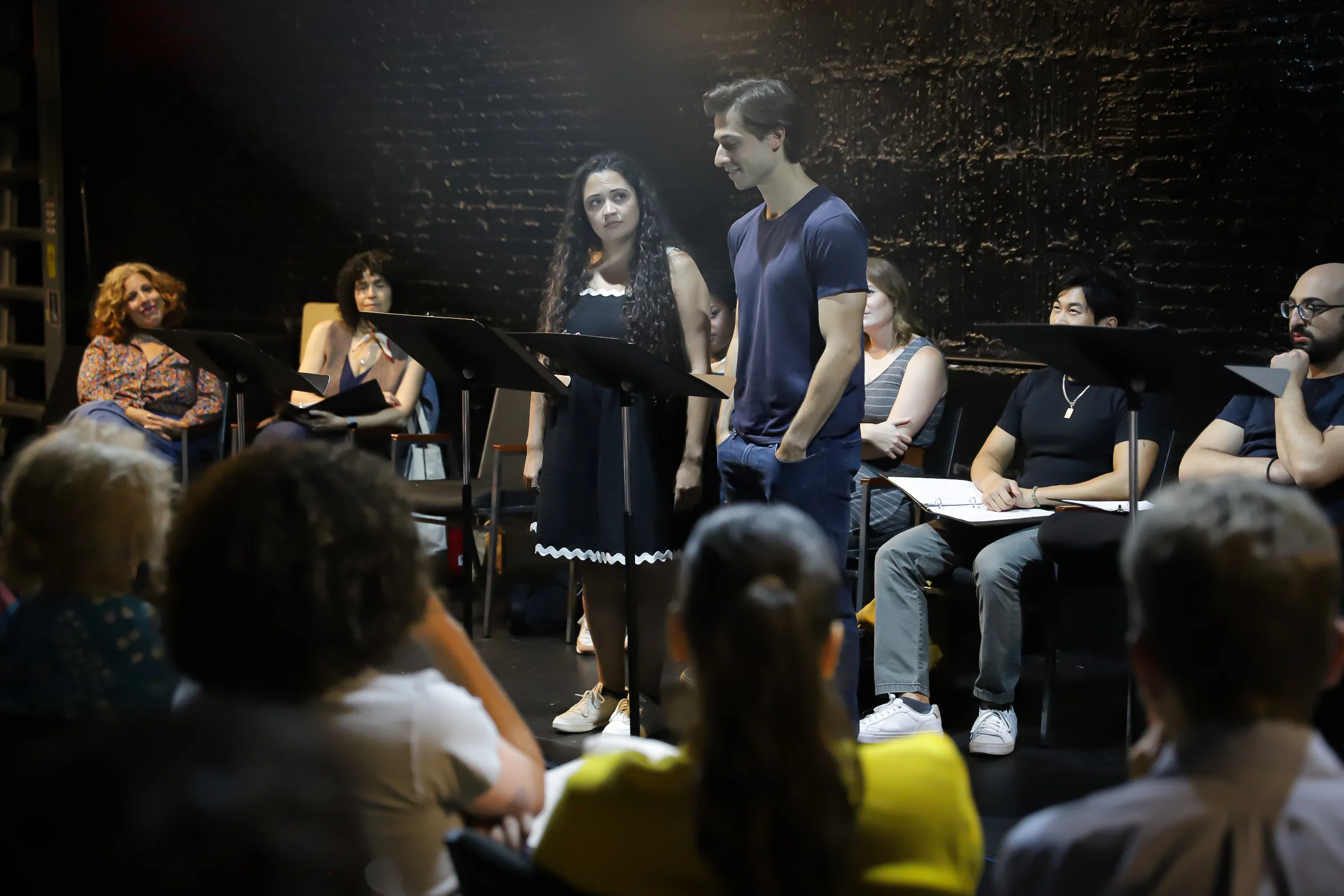 Professional actors perform the scenes developed during Mind the Gap workshops for participants and their families.