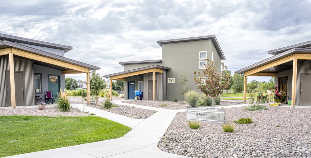 The community was intentionally built in pods of three homes, with their front porches facing each other to facilitate intergenerational interactions. Individual walkways, too, come together to put residents on common ground.
