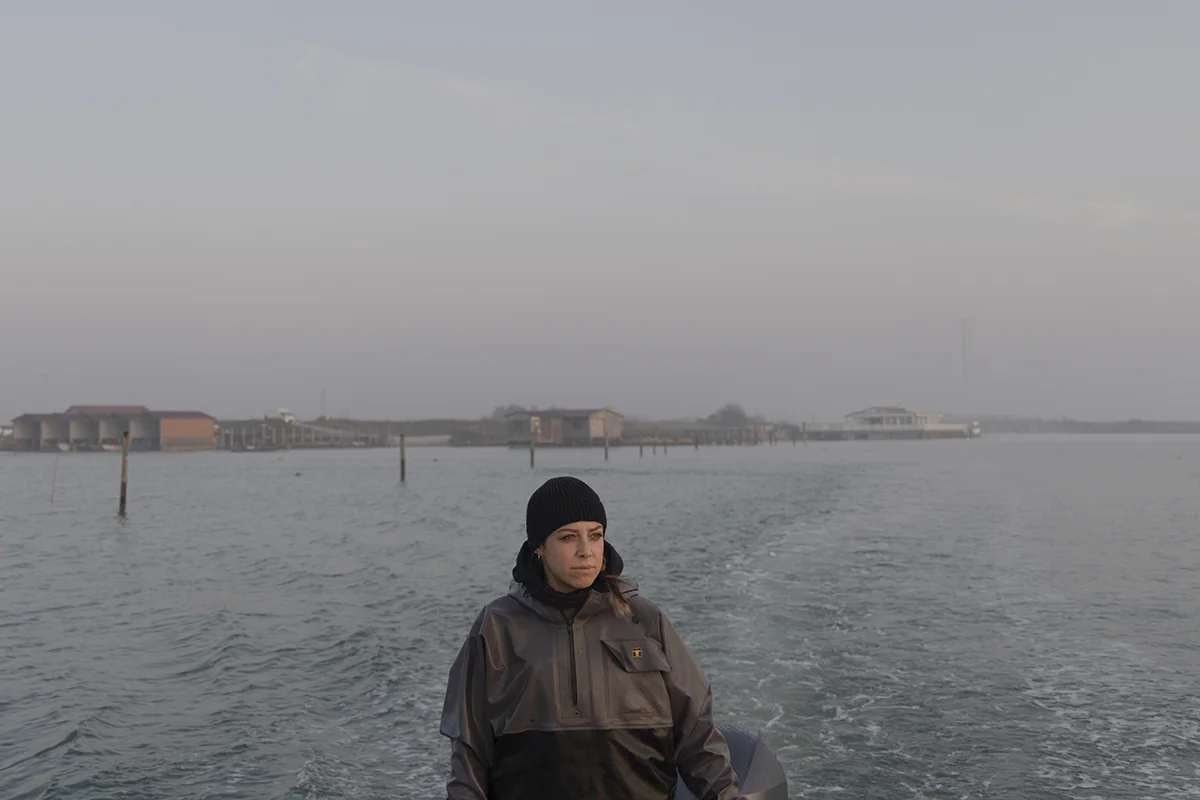 Angela Franceschetti, 27, preparing to fish for blue crabs. While the invasive species has devastated clam beds and upended traditional livelihoods, Angela is adapting, using new techniques and gear to turn the crisis into an opportunity.