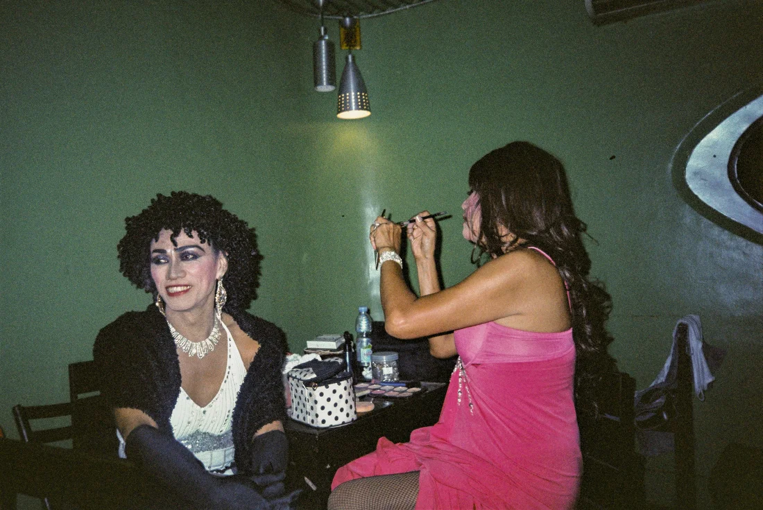 Rey sits with his friend Divine at a Manila night club. They first performed together in Japan in the 1980s. Malate, Manila, Philippines.