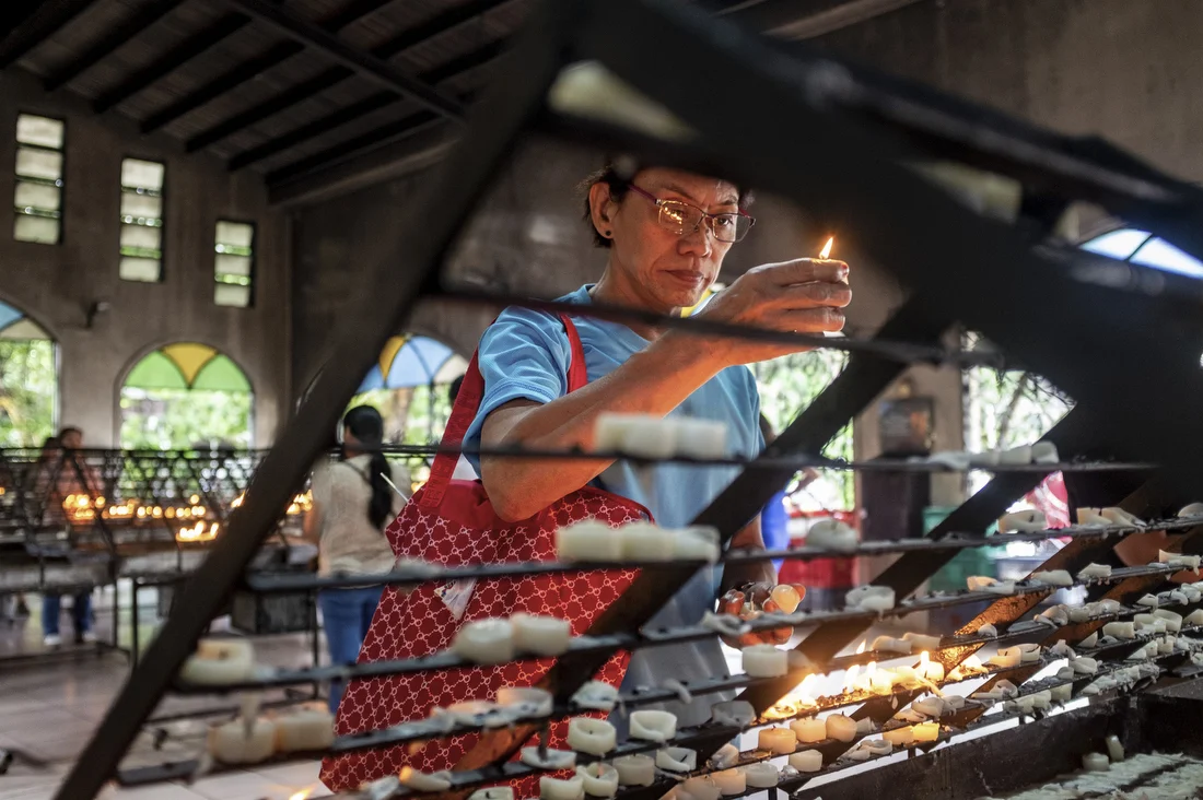 Rey Ravago lights a candle at Baclaran Church on his 64th birthday. The predominantly Catholic Philippines remains deeply influenced by conservative religious values. Metro Manila, Philippines. November 22, 2024.