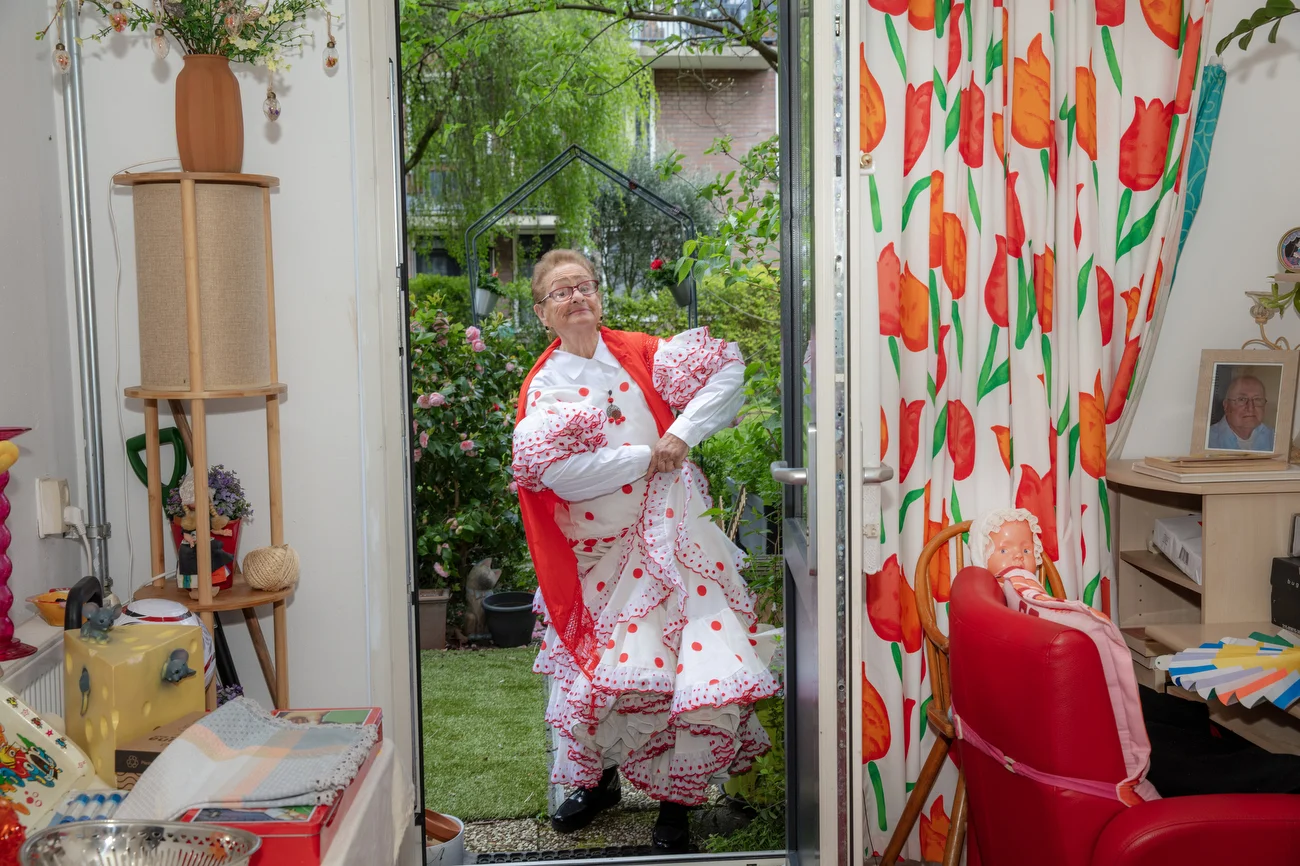 Maria Catharina de Jager-Alderding, 90, at home modeling a dress from Spain which she took around the world for a Dutch TV show, reflecting her dancing days, in Amsterdam, Netherlands on April 19, 2026.