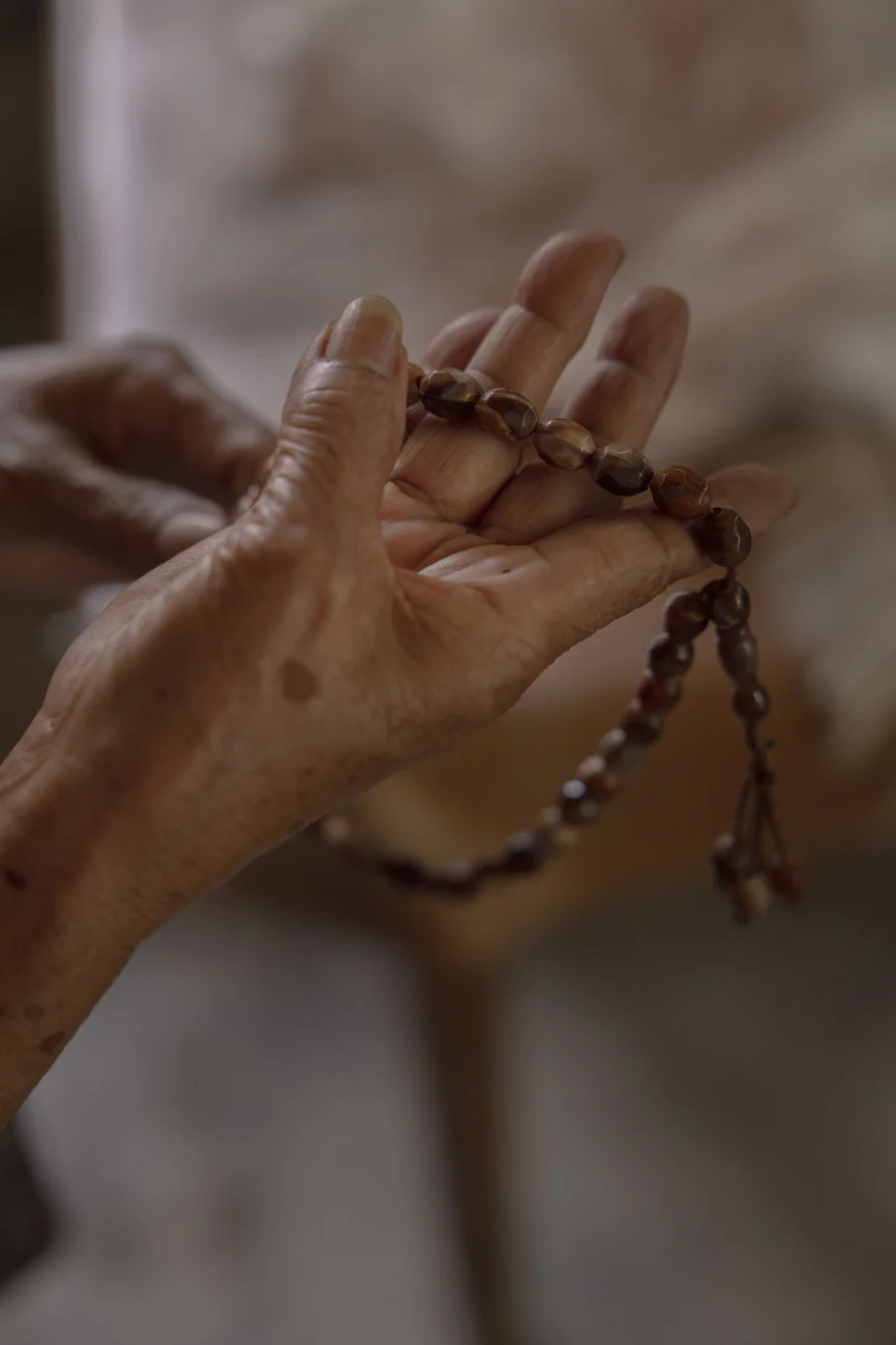 Dilma Gandao, 71, holds a misbaha, a string of prayer beads used by Muslims to keep count during prayers and recitations.