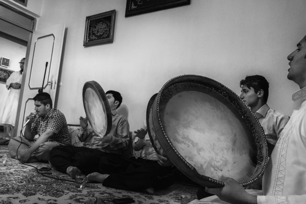 A group of daf players and singers perform a song accompanied by the daf at the beginning of the Kasenzani dhikr ceremony in Sanandaj. The daf plays a central role in the ritual space.