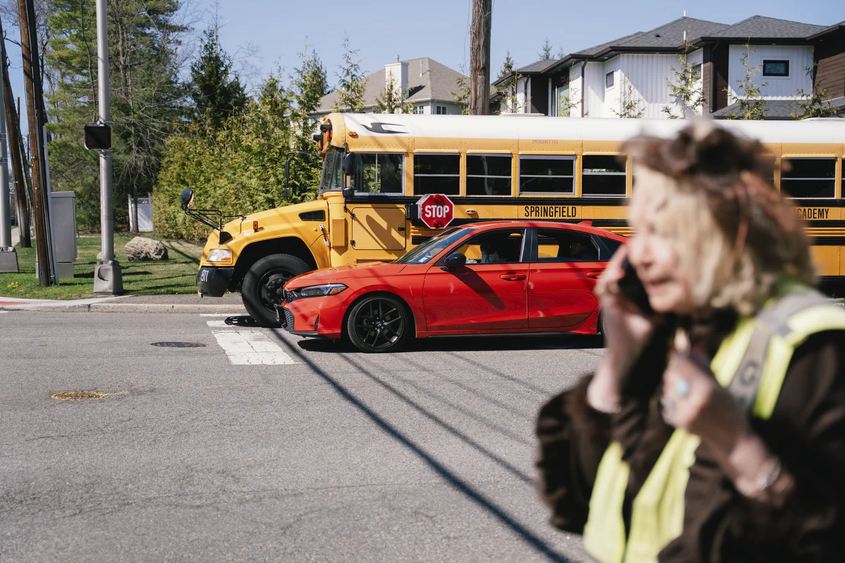 Paulette Dorflaufer takes a call on the sidewalk after her crossing guard shift in Livingston, NJ.