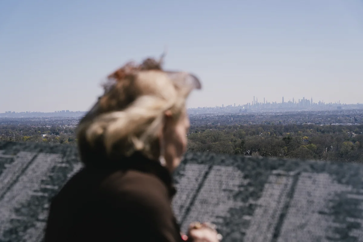 Paulette Dorflaufer stands by the Essex County Eagle Rock September 11th Memorial overlooking the NYC skyline, after her crossing guard shift is over, in West Orange, NJ.