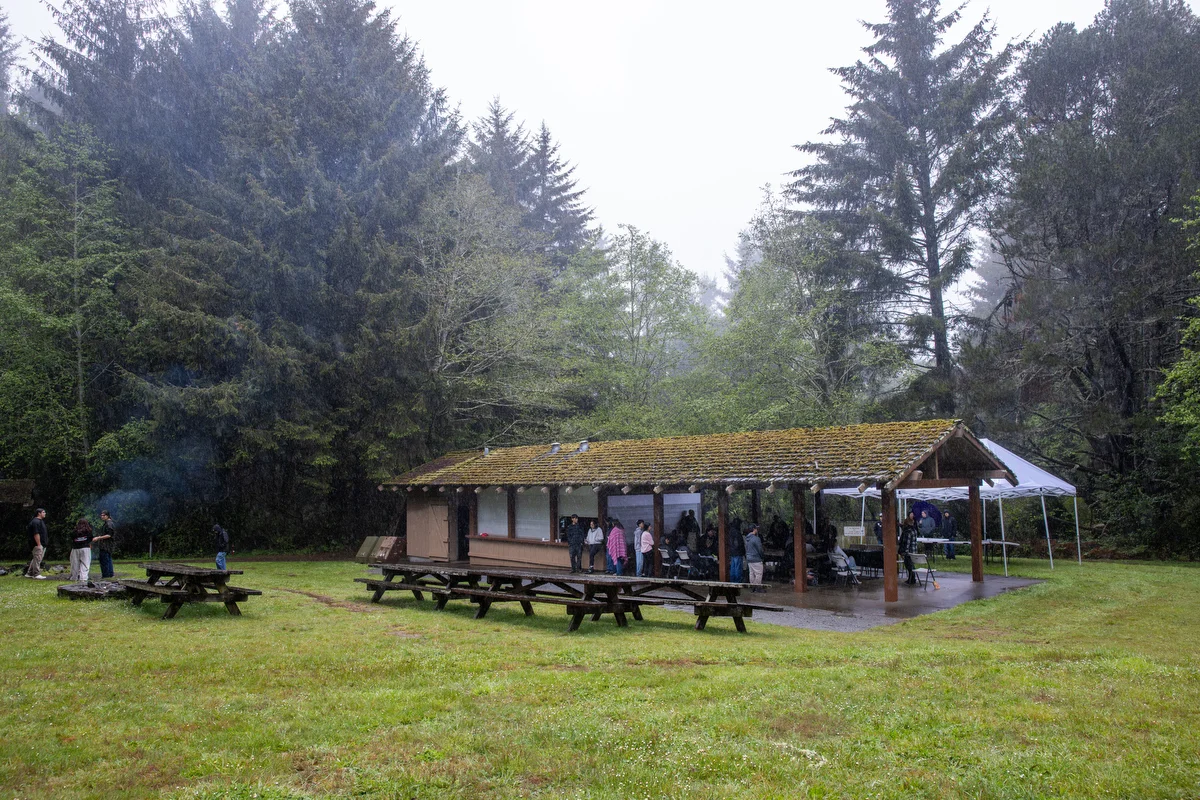 A traditional structure at Sue-Meg State Park stands within the surrounding forest. The site provided a meaningful setting for He-We-Chek' — I Survive, a day rooted in culture, place, and shared memory.