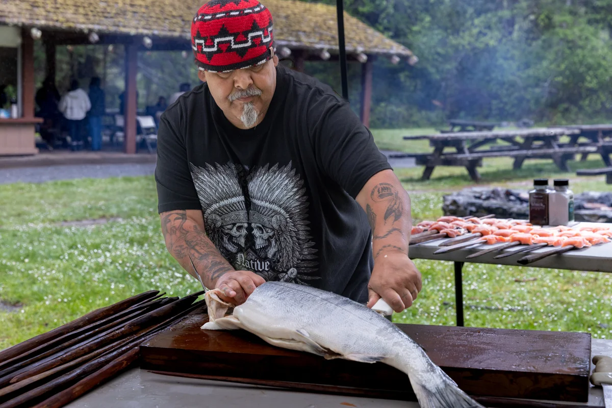 Salmon is prepared as part of the day’s cultural food traditions. The preparation and sharing of food became one way cultural knowledge was practiced and passed on.