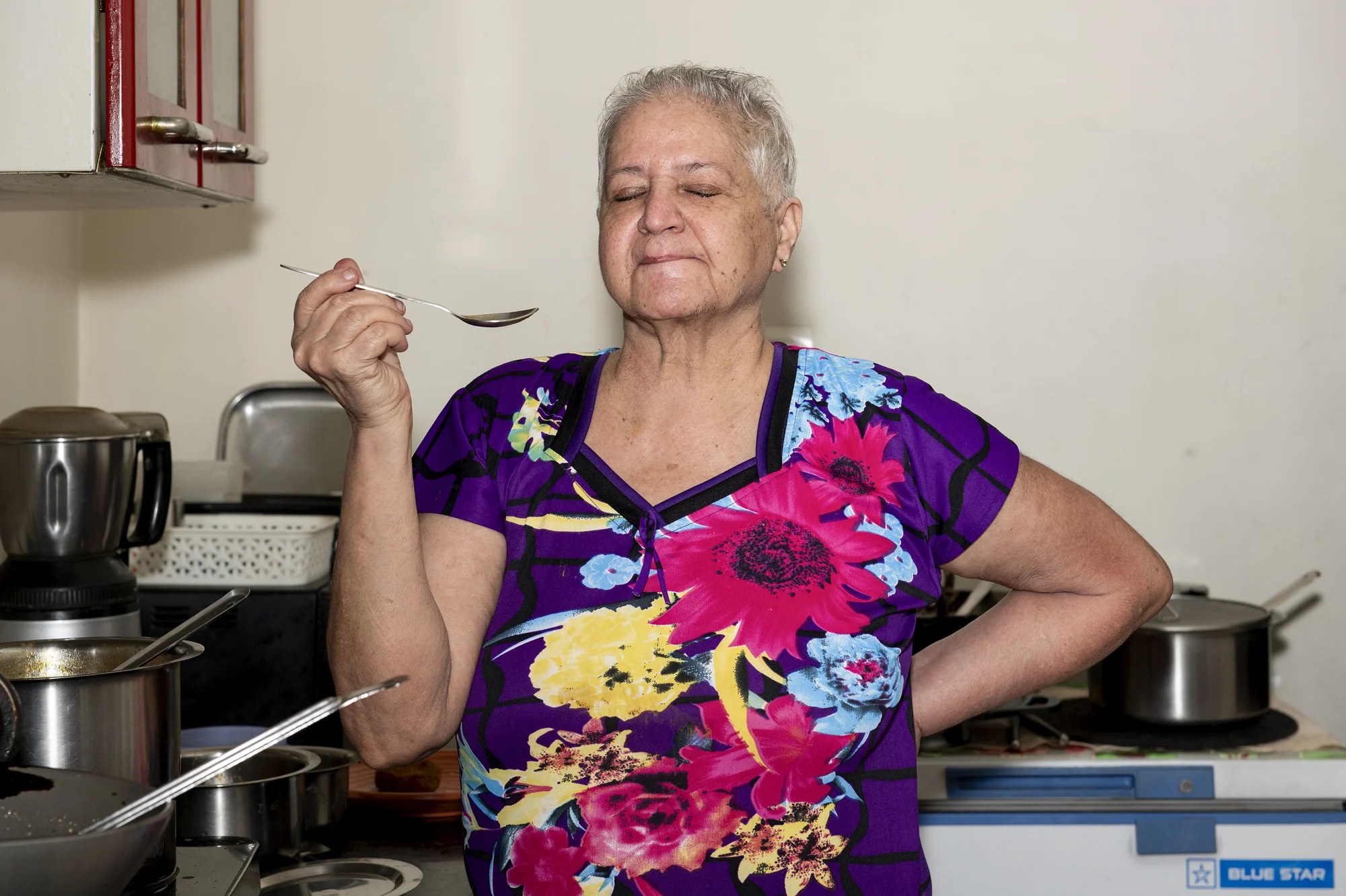 Vandana G Talreja, 69, tastes a spoonful of Sindhi curry to ensure its authentic taste in her home kitchen in Bangalore, India, on Aug. 23, 2026. Her Sindhi dishes are praised by her customers.