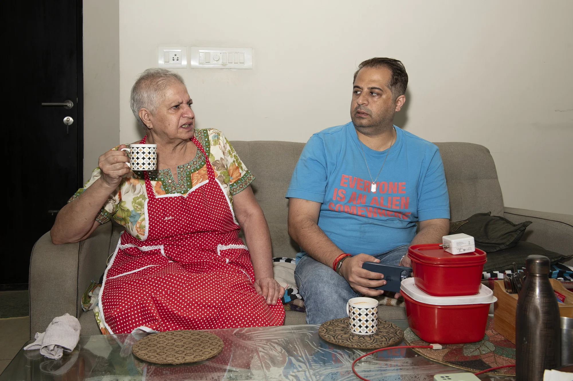 Vandana G Talreja, 69, has tea with her son, Deepak, while the two talk at her home in Bangalore, India.