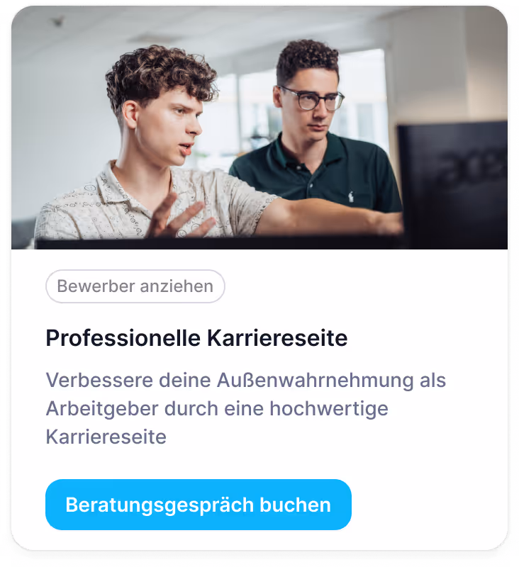 Two professionals discussing work on computer in office setting