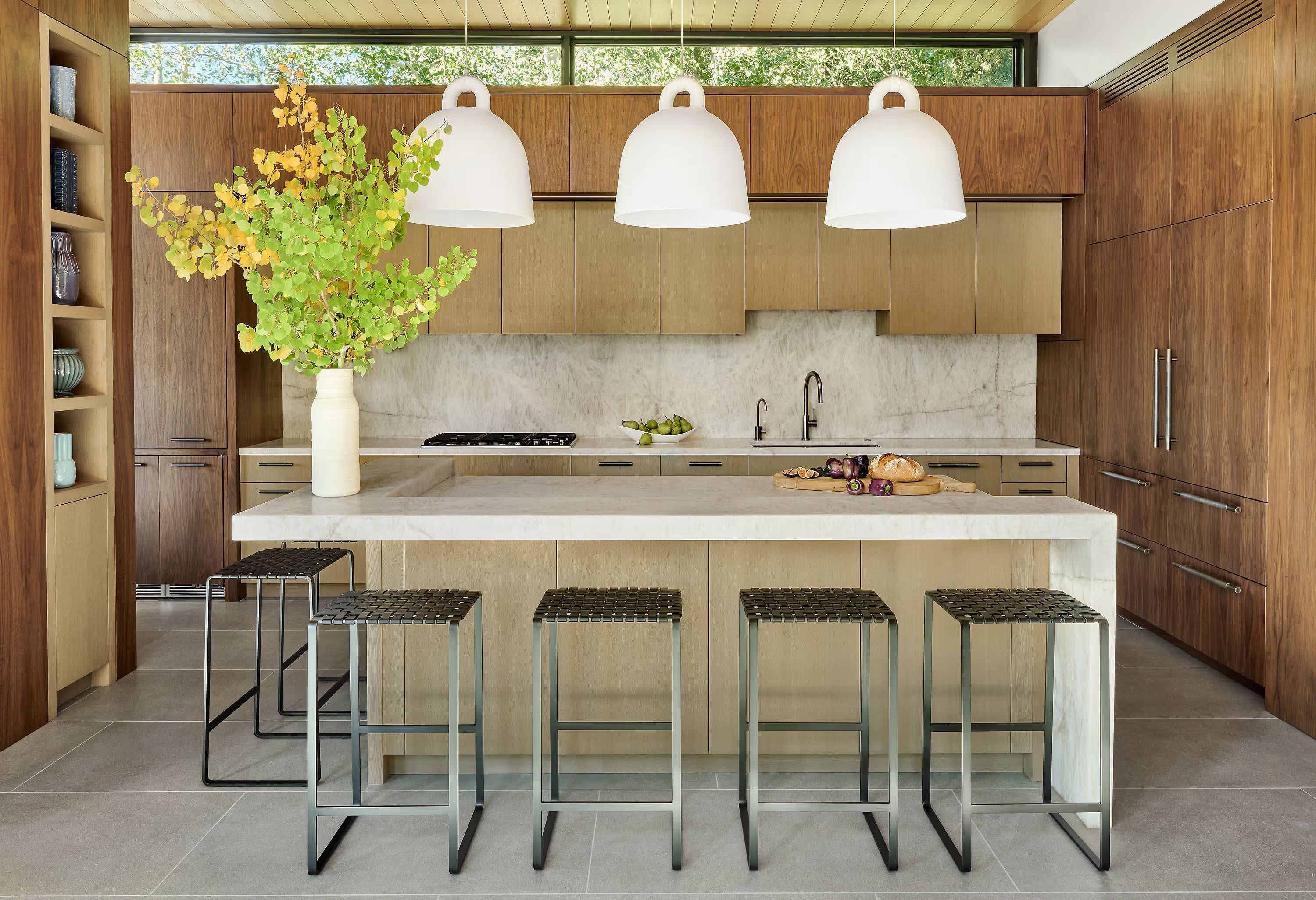 Modern kitchen with two-tone wood cabinets and a waterfall countertop