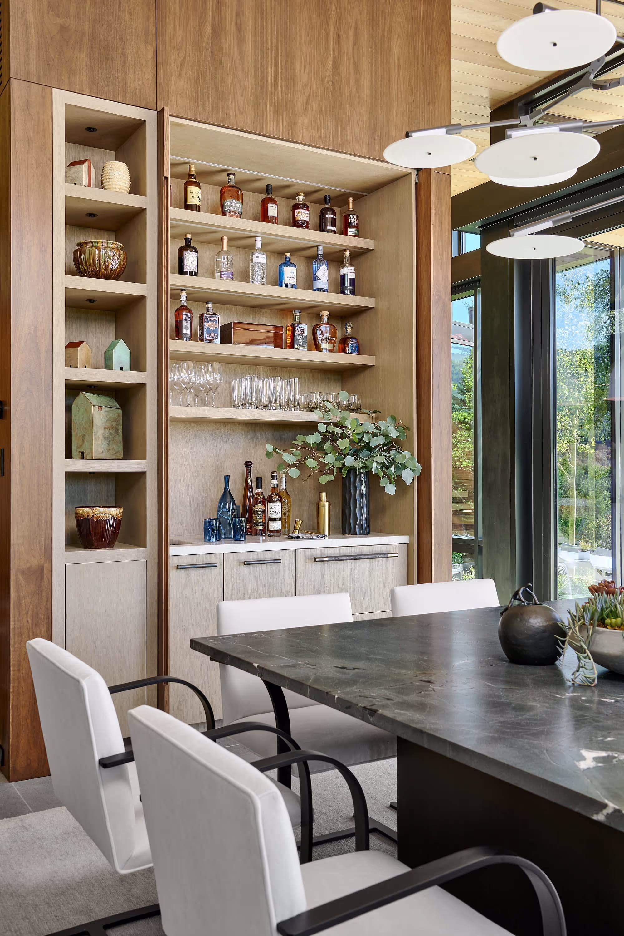 Chairs at a dining table in a mountain modern home built, by GF Woods