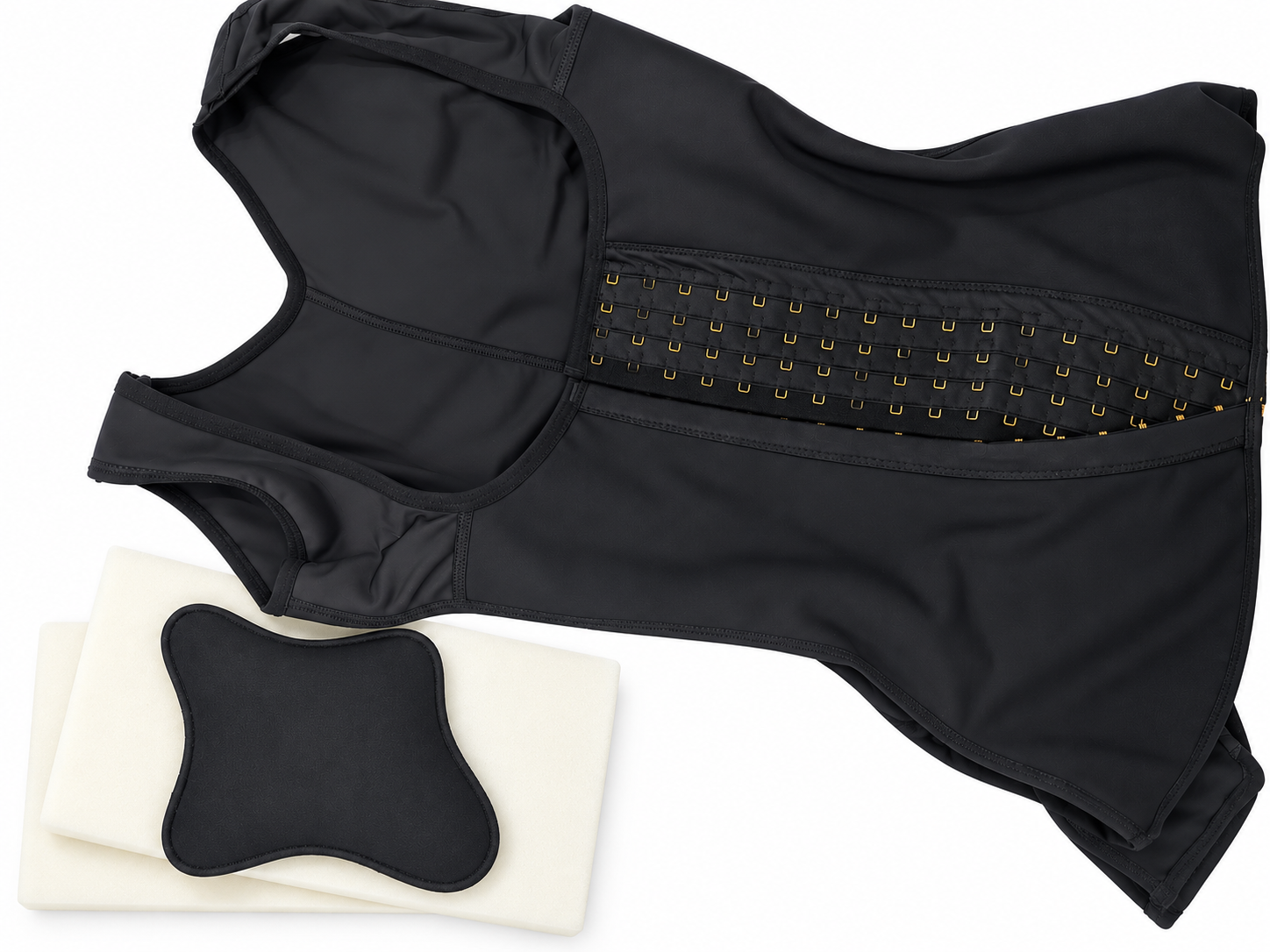 Black post-surgical compression garment with foam positioning pads and back support pillow