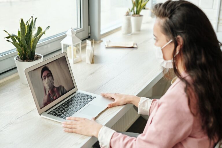 a woman talking to her employee who is working remotely