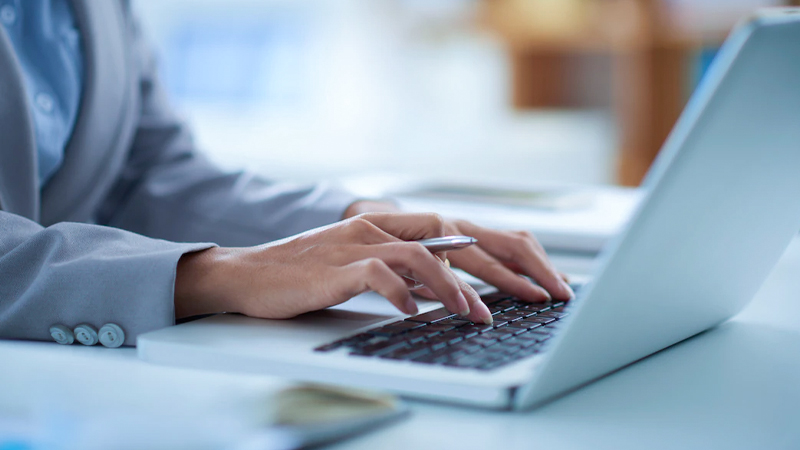 shared services fingers typing on laptop
