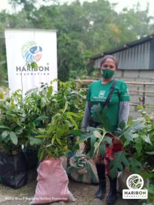 woman wearing mask posing with plants