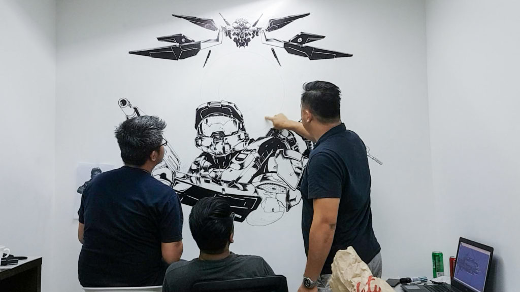 KDCI three people painting on wall